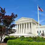 Supreme Court Justice ATTACKS Colleague—Then Forced To Apologize… Supreme Court building with American flag and trees.