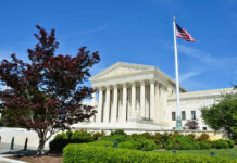 Supreme Court Justice ATTACKS Colleague—Then Forced To Apologize… Supreme Court building with American flag and trees.