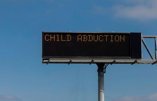 shutterstock2018906669jpg Highway sign displaying CHILD ABDUCTION message.