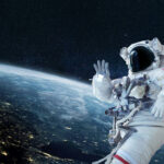 AWKWARD: Historic Trump Call Goes Horribly Wrong… Astronaut floating in space above Earth, waving.