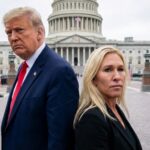 Two political figures standing in front of the Capitol building with flags in the background