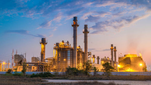 shutterstock_1723451140 Industrial plant with smokestacks at dusk.
