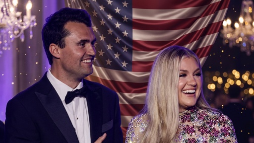 shutterstock_2757705851.jpg A smiling couple in formal attire standing in front of an American flag backdrop