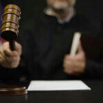 Judge hitting gavel in courtroom.