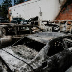 AI Clues Haunt Palisades Fire Trial Burned cars in a parking lot after a fire