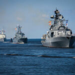 Hormuz Standoff Exposes NATO Rifts Several naval warships sailing in the ocean.