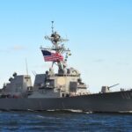 Bunker Busters POUND Iran’s Coast naval destroyer with flags sailing on open water