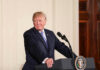 Trump Dares CNN: Go ‘Normal’ Person speaking at podium, presidential seal on front.