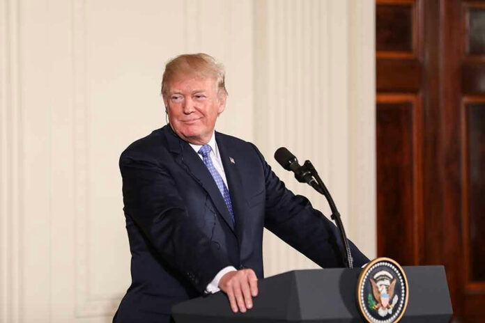 1082158661 Person speaking at podium, presidential seal on front.