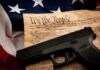 State Court Rebels On Guns Handgun on U.S. Constitution with American flag backdrop