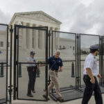 Neo-Nazi March Hijacks July 4 Security officials at the Supreme Court gates.