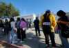 Students standing outside a high school entrance
