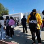 Confidence Drops as Americans Question College’s Promise Students standing outside a high school entrance