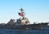 Ukraine’s Drone War Chokes Russia’s Lifeline naval destroyer with flags sailing on open water