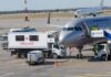 Cabin Panic Erupts — Window ‘Detaches’ An airplane at an airport with an ambulance and ground crew nearby