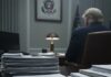 A stack of documents labeled 'Articles of Impeachment' on a desk in a government office