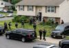 Law enforcement officers conducting a raid in a residential neighborhood
