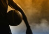 Basketball player silhouette with a ball in hand.