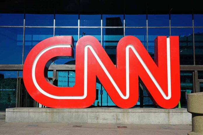 Large red CNN logo outside a building.