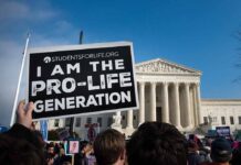 Person holds Pro-Life Generation sign at protest.