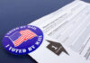 Mail-in ballot application with I Voted By Mail sticker.